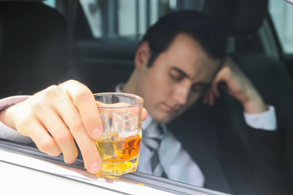 A traveler appearing intoxicated, preparing to drive home.