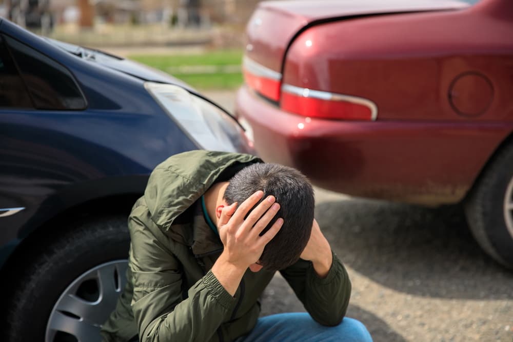 Unhappy rideshare driver and vehicle involved in a collision.