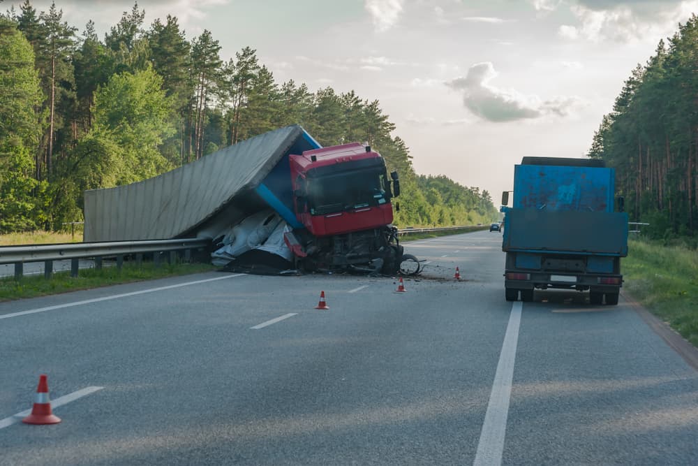 A truck has rolled over on the road, causing a crash.